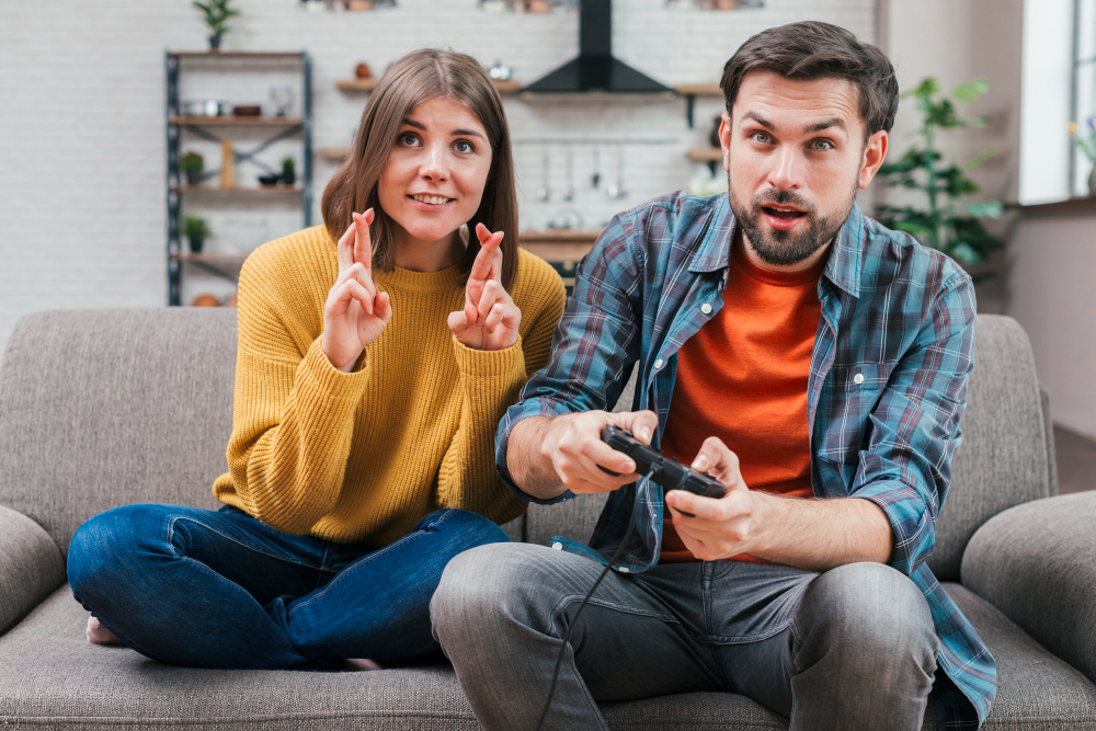 a couple sitting together and playing game